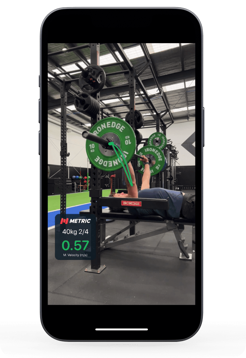 Metric tracking a bench press in real time, bar path overlaid on video